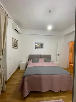 a bedroom with a large bed in a room at LOCAZIONE TURISTICA PAOLUCCI in Rome