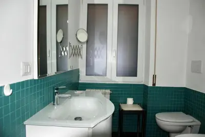 a bathroom with a white sink and a toilet at LOCAZIONE TURISTICA PAOLUCCI in Rome