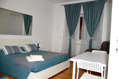 a bedroom with a bed and a table and a chair at LOCAZIONE TURISTICA PAOLUCCI in Rome