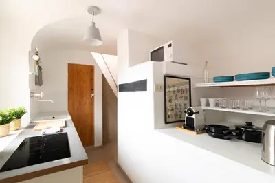 a kitchen with white counters and a white refrigerator at Rooftop Colosseum in Rome