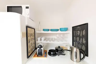 a kitchen counter with a shelf with dishes on it at Rooftop Colosseum in Rome