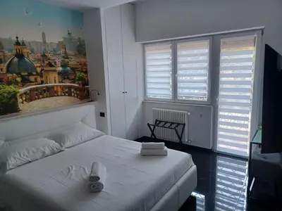 a bedroom with a bed with flip flops on it at Balcone sul parco in Rome