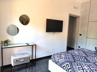 a bedroom with a bed and a tv on the wall at Balcone sul parco in Rome