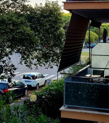 a car parked in a parking lot next to a house at Balcone sul parco in Rome