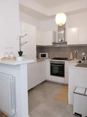 a kitchen with white cabinets and a stove top oven at Noh collection 3BDR apartment- Trastevere Area in Rome