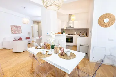 a kitchen and living room with a white table and chairs at Noh collection 3BDR apartment- Trastevere Area in Rome