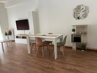 a dining room with a white table and chairs at Stazione Tiburtina - Camesena Apartment in Rome