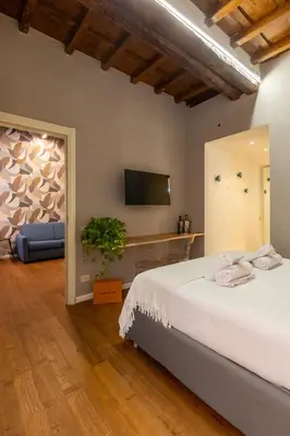a bedroom with a bed and a flat screen tv at Roma Centro Storico Luxury - Via del Corso in Rome