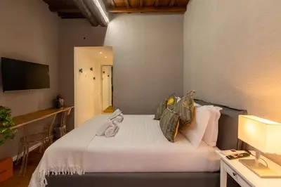 a bedroom with a white bed with a mirror at Roma Centro Storico Luxury - Via del Corso in Rome