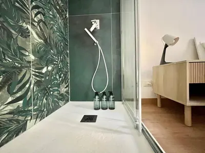 a bathroom with a shower with bottles on the floor at VATICAN VIBES in Rome