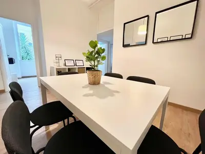 a white table with chairs and a potted plant on it at VATICAN VIBES in Rome