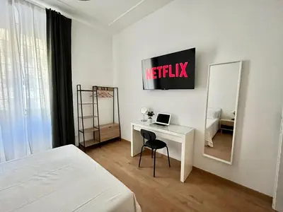a bedroom with a desk and a bed and a mirror at VATICAN VIBES in Rome