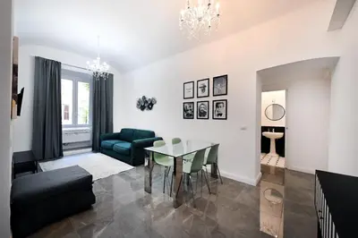 a living room with a table and a couch at VATICAN DESIGN APARTMENTS in Rome