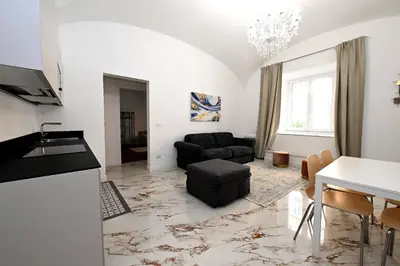 a living room with a couch and a table at VATICAN DESIGN APARTMENTS in Rome