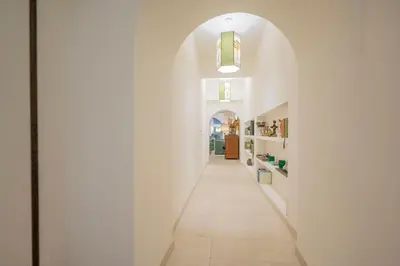 a hallway with white walls and an archway at Via Giulia Charming Atelier apartment in Rome