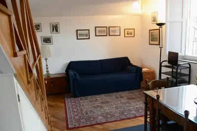 a blue couch sitting in a living room at Appartamento Coronari in Rome
