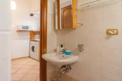 a bathroom with a white sink and a shower at EasyTopStay - Monti Studio Apartment in Rome