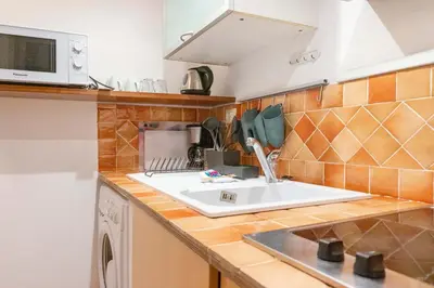 a kitchen with a sink and a microwave at EasyTopStay - Monti Studio Apartment in Rome