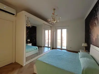 a bedroom with a blue bed and a mirror at Oasi Urbana San Paolo in Rome