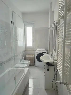a bathroom with two sinks and a tub and a toilet at Oasi Urbana San Paolo in Rome