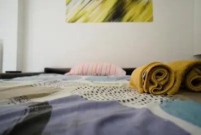 a bed with two towels on top of it at Ermete Vatican House in Rome