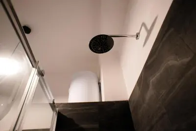 a room with a staircase with a light on the wall at Ermete Vatican House in Rome