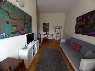 a living room with a couch and a flat screen tv at Casa Campo de' Fiori in Rome