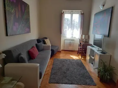 a living room with a couch and a television at Casa Campo de' Fiori in Rome