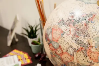 a close up of a globe on a table with a plant at St Peter's View in Rome
