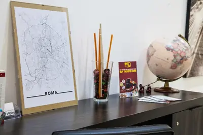 a wooden table with a vase and a picture on it at St Peter's View in Rome