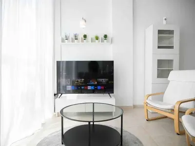 a living room with a tv and a coffee table at Window on Rome in Rome