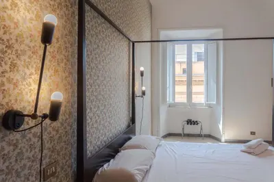 a bedroom with a bed and a window at EasyTopStay - Villa Borghese Large Apartment in Rome