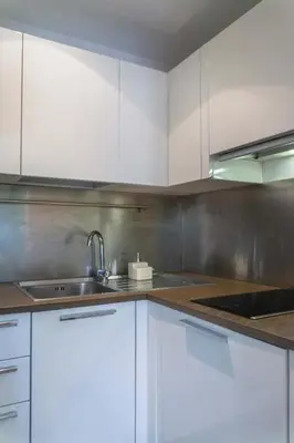 a kitchen with white cabinets and a sink at EasyTopStay - Piazza Venezia Charming & Bright Apt in Rome