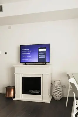 a flat screen tv sitting on top of a fireplace at EasyTopStay - Stylish Flat with Garden in Rome