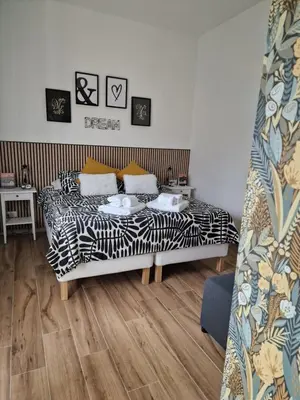 a bedroom with a bed with black and white sheets at Home K&Y Élite in Rome