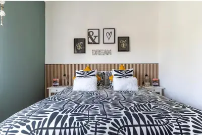 a bedroom with a black and white bed with two pillows at Home K&Y Élite in Rome