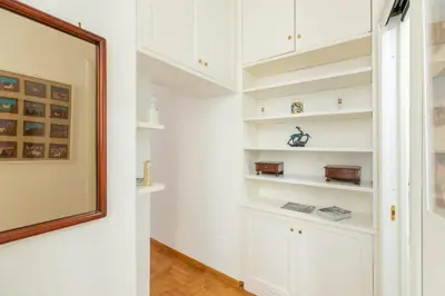a hallway with white cabinets and a picture on the wall at iFlat Red Roman Apartament in Rome