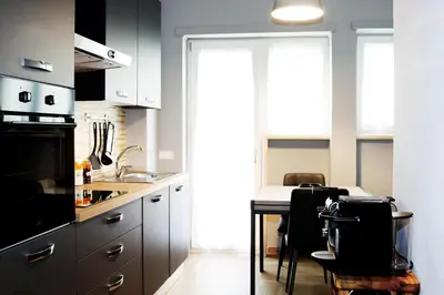a kitchen with a counter and a table with chairs at VATICAN HOME ROMA in Rome