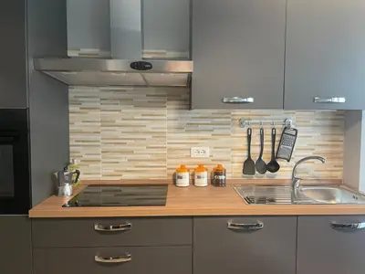 a kitchen with a sink and a counter top at VATICAN HOME ROMA in Rome