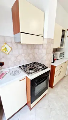a kitchen with a stove top oven in a kitchen at Giulia Home Apartment Metro Conca D'Doro Roma in Rome