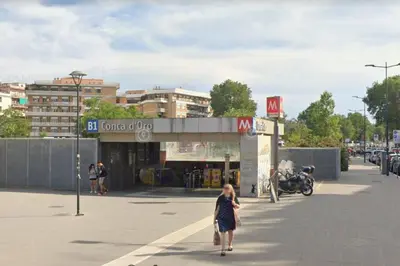 a woman walking down a street in front of a store at Giulia Home Apartment Metro Conca D'Doro Roma in Rome