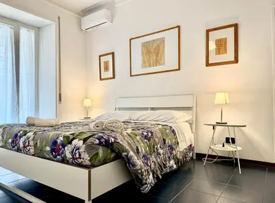 a bedroom with a bed and two tables and two lamps at Ottaviano - 10 min dal Vaticano in Rome