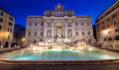 a fountain in front of a building at night at Ottaviano - 10 min dal Vaticano in Rome
