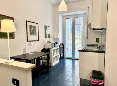 a kitchen with a table and a counter top at Ottaviano - 10 min dal Vaticano in Rome