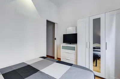 a bedroom with a bed and a flat screen tv at Colors & Culture near Colosseum in Rome