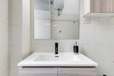 a bathroom with a white sink and a mirror at Colors & Culture near Colosseum in Rome
