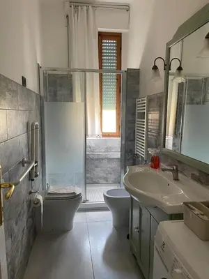 a bathroom with a toilet and a sink and a shower at Brando Apartment in Rome