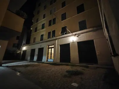 an empty building at night with a light on it at Brando Apartment in Rome