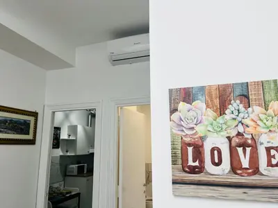 a painting of flowers in vases with the word love at Suite San Damaso in Rome