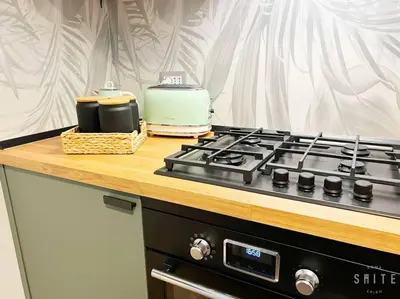 a kitchen counter with a stove and a toaster at Roma Suite Epiro in Rome